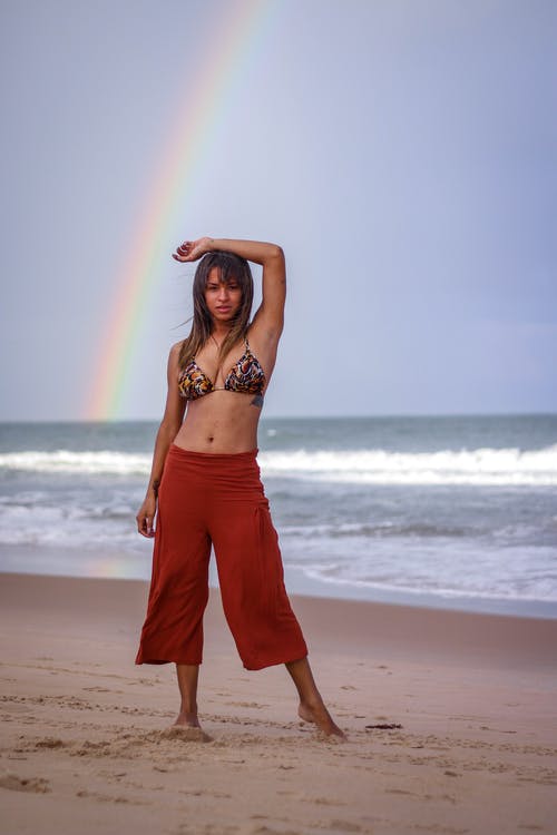 女人站在海边俯瞰彩虹 · 免费素材图片
