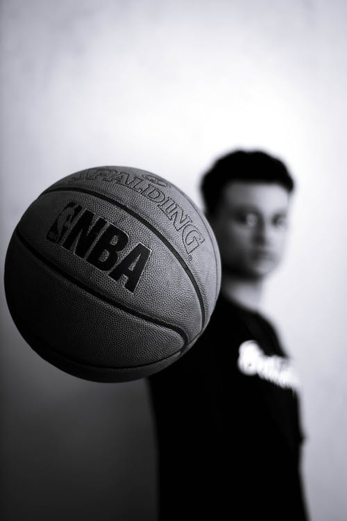 男子手持nba篮球的灰度照片 · 免费素材图片