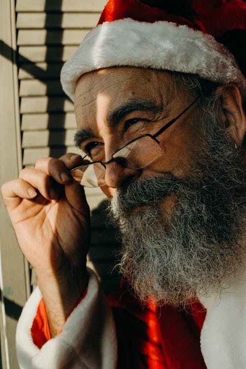 关闭一个穿着圣诞老人服装的男人的照片 · 免费素材图片