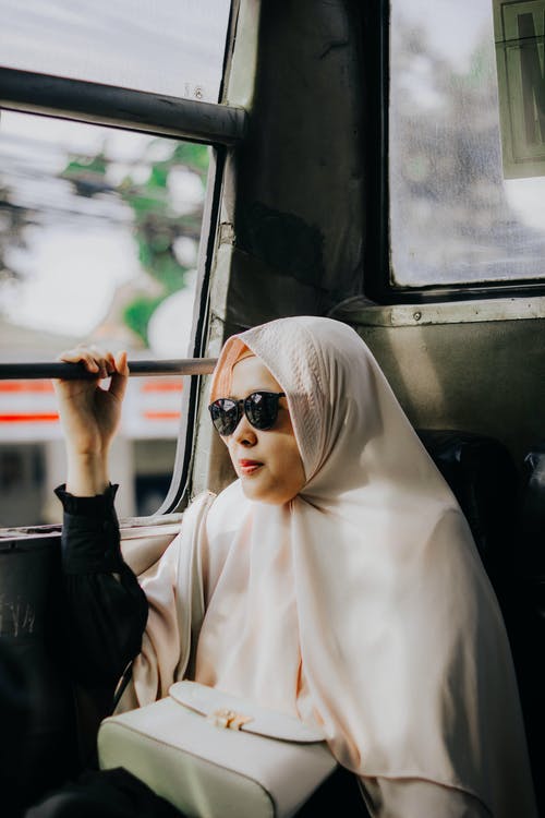 盖头坐在窗边的女人 · 免费素材图片