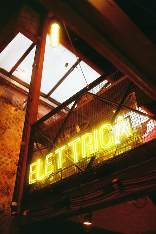 带有elettrica标题的招牌在夜间照明建筑物 · 免费素材图片