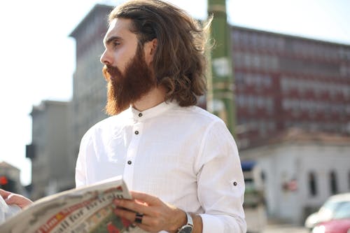 拿着报纸的白色长袖的男人 · 免费素材图片