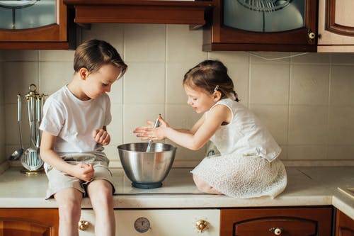孩子们在厨房台面上玩的照片 · 免费素材图片