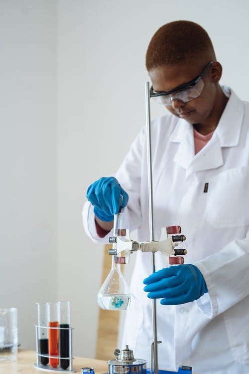 专注于非洲裔美国防护眼镜研究人员使用液体进行测试 · 免费素材图片