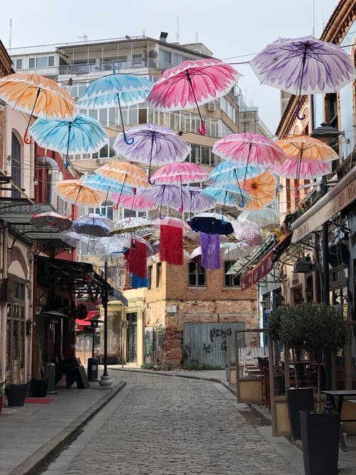 五颜六色的雨伞，装饰旧城的街道 · 免费素材图片