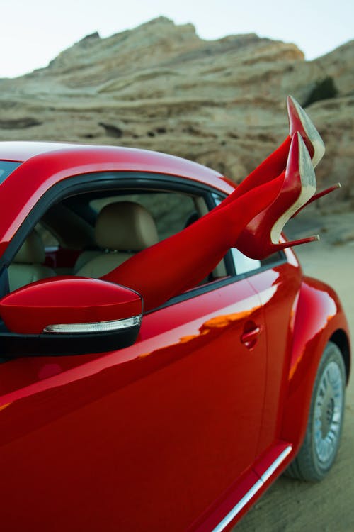 棕色沙滩上的红色和黑色车 · 免费素材图片
