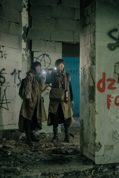 2名穿着棕色大衣的男人站在白墙旁边 · 免费素材图片