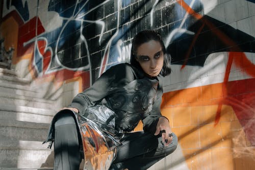 坐在黑色的椅子上的黑色皮夹克的女孩 · 免费素材图片