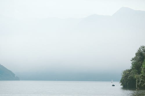 小船在平静的海水对山 · 免费素材图片