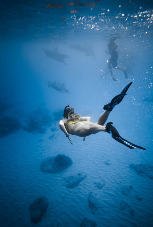 不可识别的女人在海中游泳水下 · 免费素材图片