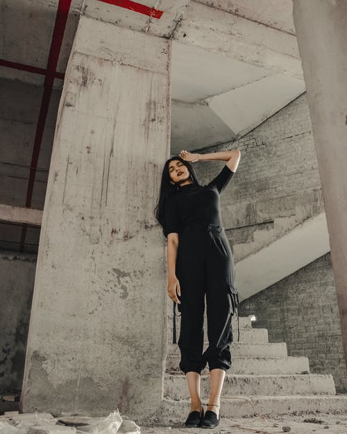 黑色长袖衬衫和黑色的裤子，站在灰色的混凝土楼梯上的女人 · 免费素材图片