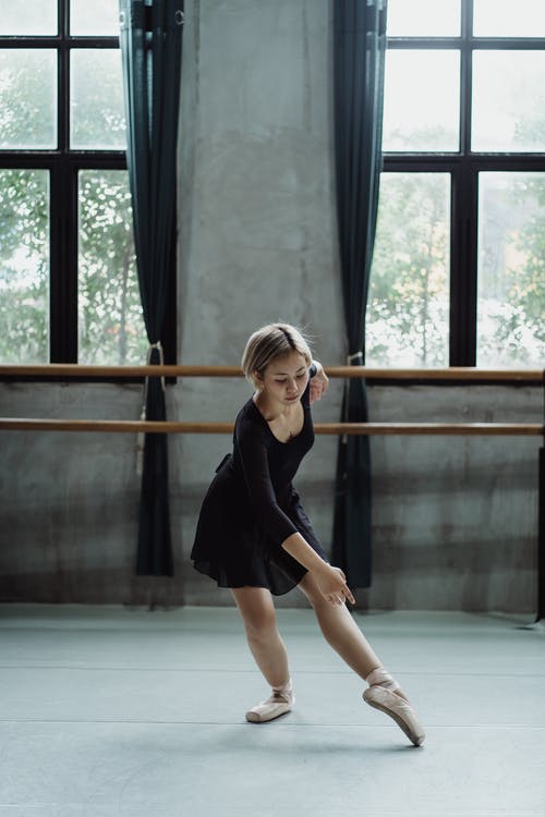 做舞蹈的年轻芭蕾舞女演员在演播室移动 · 免费素材图片