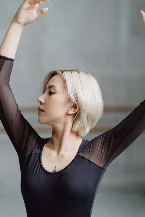 女性年轻的亚洲芭蕾舞演员在灯光工作室中跳舞 · 免费素材图片