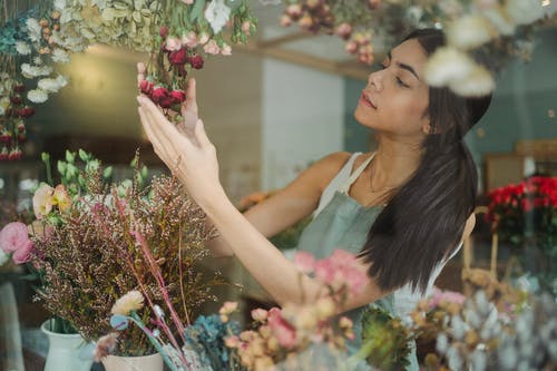 在花店工作的有吸引力的女性花店 · 免费素材图片