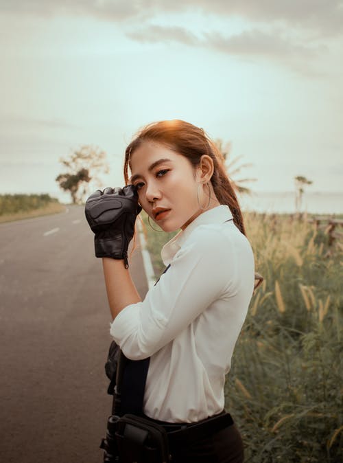 司机手套站在农村公路上的漂亮亚洲女人 · 免费素材图片