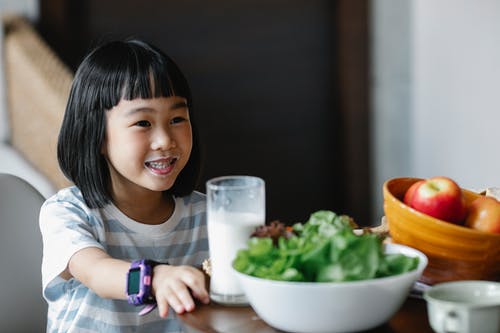 快乐的亚洲女孩喝牛奶 · 免费素材图片