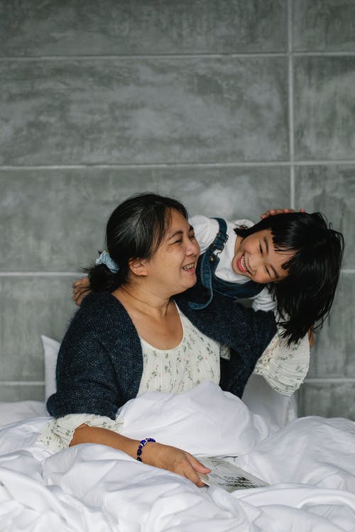 母亲和孩子在床上 · 免费素材图片