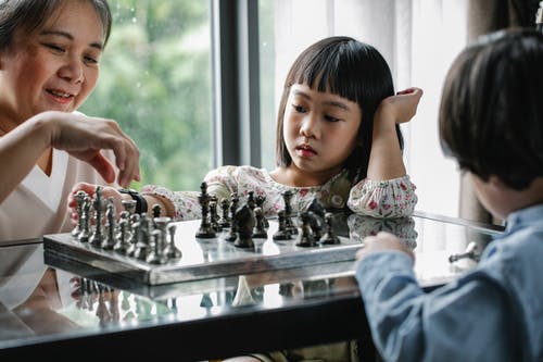 母亲和孩子在家里下棋 · 免费素材图片
