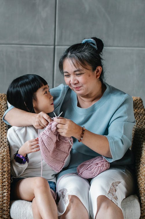 内容亚洲奶奶拥抱女孩和编织 · 免费素材图片