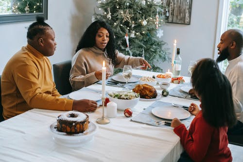 黑人家庭在圣诞节假期在餐桌旁用餐 · 免费素材图片