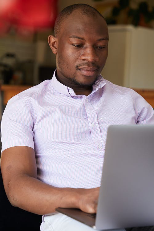 黑人男子在笔记本电脑上检查电子邮件 · 免费素材图片