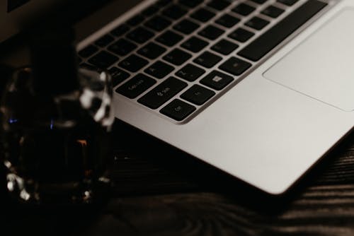 黑色桌上的银色macbook Pro · 免费素材图片