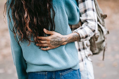 民族纹身的人轻轻拥抱女友 · 免费素材图片