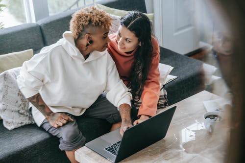 时尚多样的女同性恋夫妇与笔记本电脑 · 免费素材图片