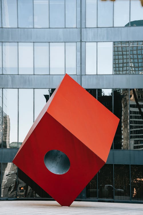 在现代城市广场上的未来派红色立方体雕塑 · 免费素材图片