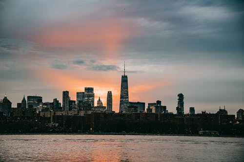 夕阳下的天空下沿海大都市的城市景观 · 免费素材图片