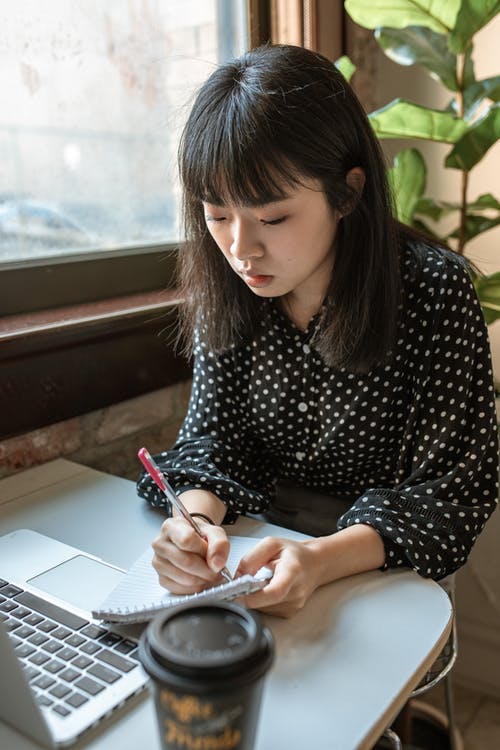 黑色和白色圆点长袖衬衫写在白纸上的女人 · 免费素材图片