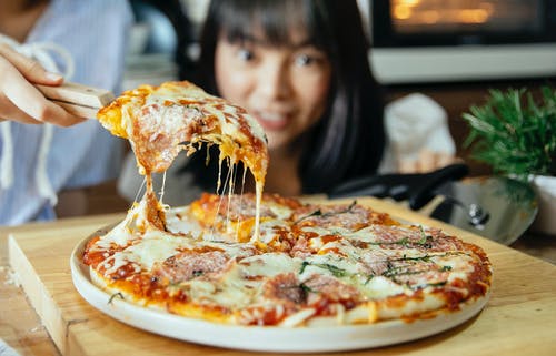 黑色衬衫吃披萨的女孩 · 免费素材图片