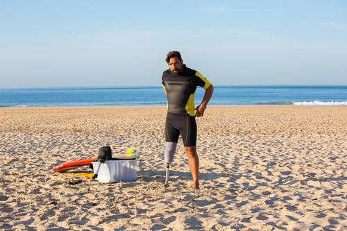 积极的假肢在海滩上的冲浪者 · 免费素材图片