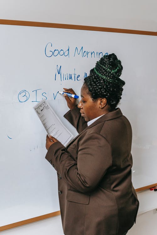 在白板上集中黑人老师写作任务 · 免费素材图片