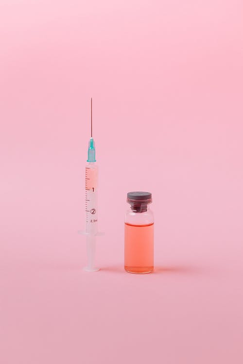 粉红色表面上的疫苗 · 免费素材图片