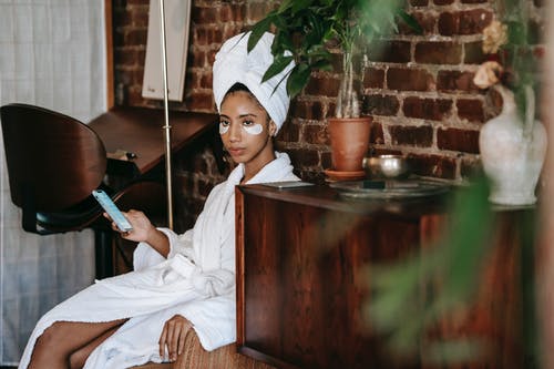 坐在棕色的木桌上的白色礼服衬衫的女孩 · 免费素材图片