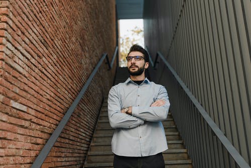 白色礼服衬衫和黑色的裤子，站在棕色木桥上的男人 · 免费素材图片