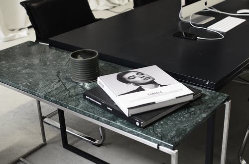 黑色和白色的书，在黑色的桌子上 · 免费素材图片