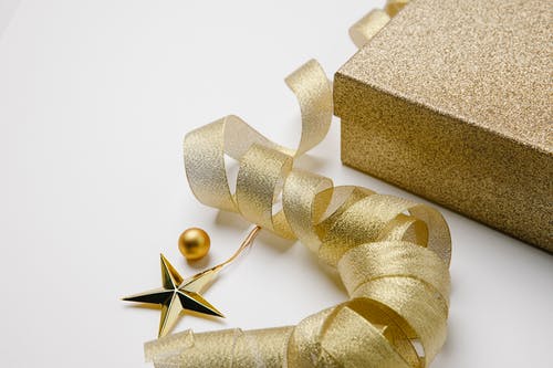 棕色礼品盒上的金色彩带 · 免费素材图片