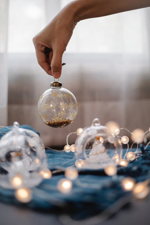 持有透明玻璃灯泡的人 · 免费素材图片