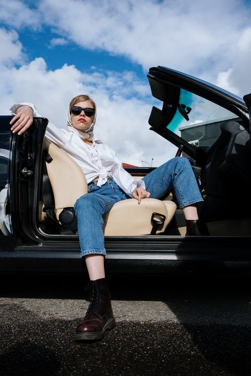 蓝色牛仔夹克和白衬衫，坐在车上的女人 · 免费素材图片