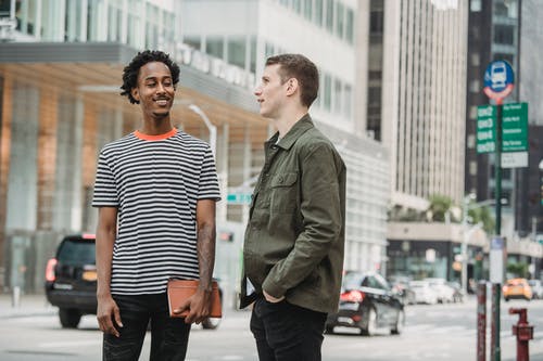 站在黑色和白色条纹衬衫的女人旁边的绿色西装外套的男人 · 免费素材图片