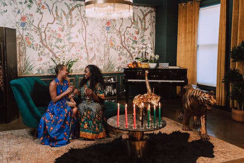 两个女人坐在绿色的沙发上 · 免费素材图片