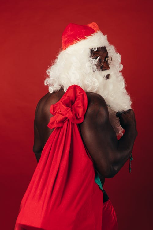光着膀子的男人，在圣诞老人装着礼物 · 免费素材图片