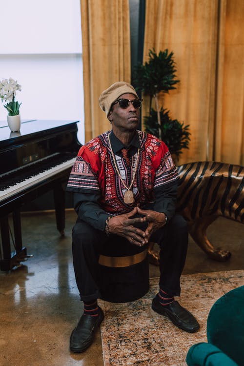 男子坐在黑色的凳子上的照片 · 免费素材图片