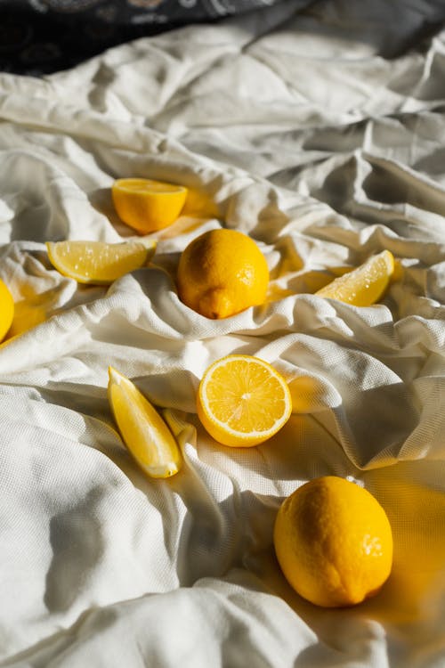 在白色纺织品上切柠檬 · 免费素材图片