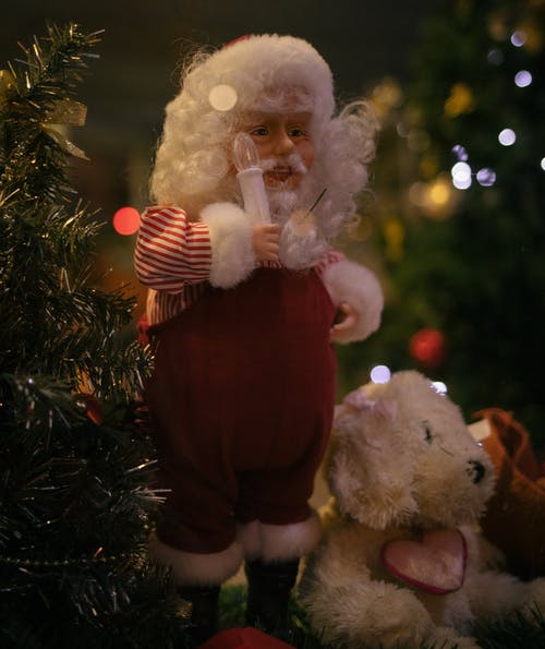 圣诞老人抱着白熊毛绒玩具 · 免费素材图片