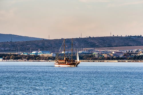 白色和棕色的小船在海上 · 免费素材图片