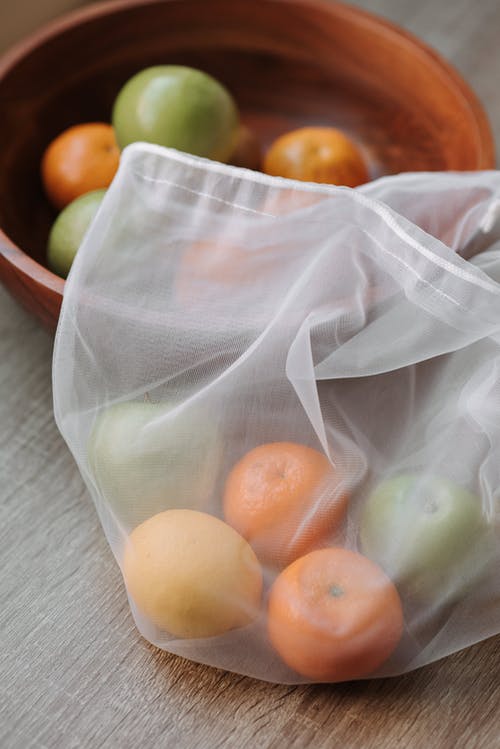 透明塑料包装上的棕色圆形水果 · 免费素材图片