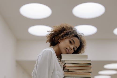 女人携带书籍的照片 · 免费素材图片